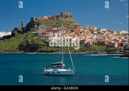 Castelsardo,Sassari,Sardinia,Italy, 10/4/2016.Sailing boat on the sea in front of the colored town of Castelsardo,near the port. Stock Photo