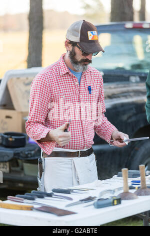 A butcher prepares to slaughter a hog for a Cajun Boucherie part of the traditional week long Mardi Gras festivities February 8, 2016 in Eunice, Louisiana. The old fashion community event involves slaughtering a whole hog and using and cooking all parts for the guests. Stock Photo