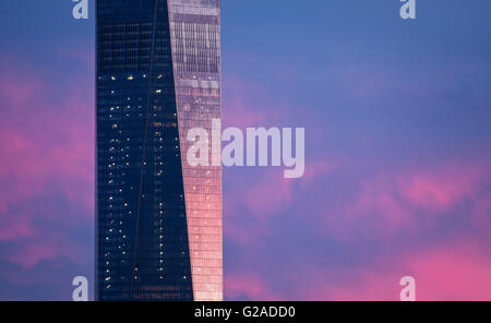 Part of One World Trade Center against dramatic sky at dusk Stock Photo