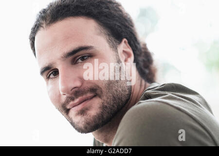 Portrait of young man with long curly hair Stock Photo