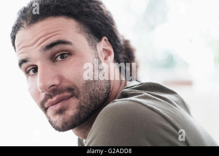 Portrait of young man with long curly hair Stock Photo
