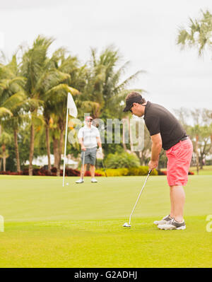 Two men playing golf Stock Photo