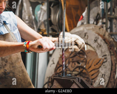 Female blacksmith working in workshop Stock Photo