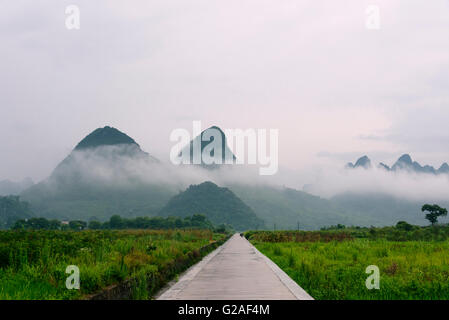 Karst hills in morning mist, Yangshuo, Guangxi Province, China Stock Photo