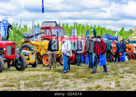 Emmaboda, Sweden - May 14, 2016: Forest and tractor (Skog och traktor) fair. People looking at classic vintage tractors. Stock Photo