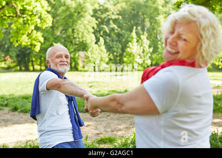 Happy senior couple dancing together in nature in summer Stock Photo