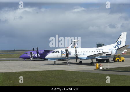A Dornier 328 painted in the purple colours of Loganair, a Flybe franchise partner, and a Loganair G-LGNG (Saab 340 - MSN 327) at Kirkwall airport.