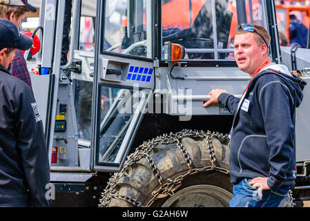 Emmaboda, Sweden - May 14, 2016: Forest and tractor (Skog och traktor) fair. Salesperson talking to visitors about the Vimek for Stock Photo
