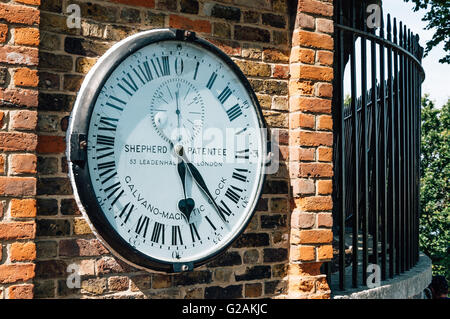 LONDON, UK - AUGUST 22, 2015:  The Shepherd gate 24-hour clock, outside the Royal Greenwich Observatory. Galvano magnetic clock. Stock Photo