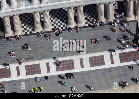 A close up aerial view of people sitting on the steps of St Pauls Cathedral