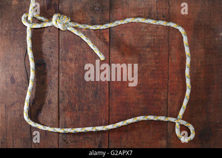 Picture frame made from rope on nice wooden background Stock Photo