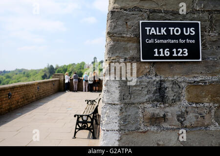 A Samaritans sign on the entrance to a bridge with a telephone number to call for help Stock Photo