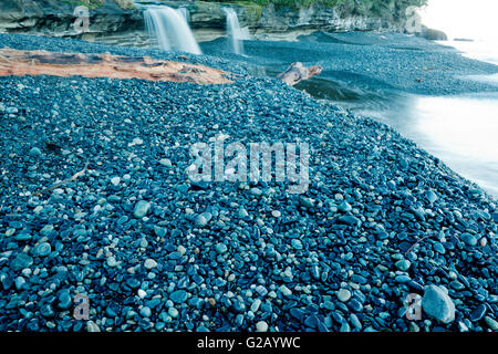 Waterfall and pebble stone in the morning beach, Sandcut Beach Stock Photo