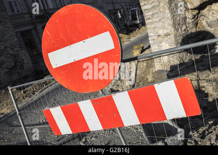Round red sign No Entry hanging on urban road barrier Stock Photo