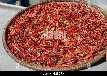 Chili on a plate drying in the sun on the Annapurna Circuit in Nepal Stock Photo