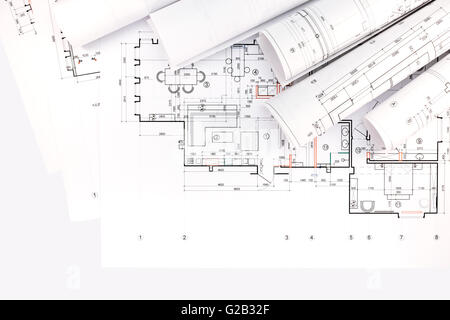 architects workspace with rolled construction plans and blueprints Stock Photo