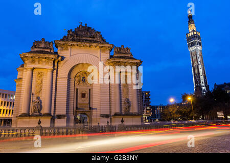 Paris Gate with Belfry of the Town Hall in the background in Lille in France in the evening Stock Photo