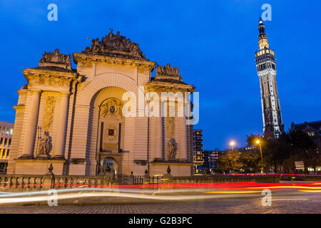 Paris Gate with Belfry of the Town Hall in the background in Lille in France in the evening Stock Photo