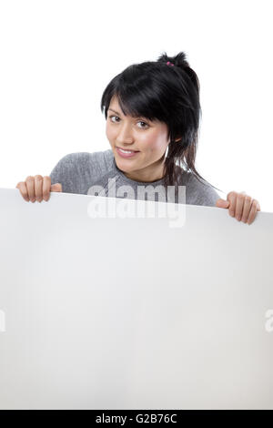Close up shot of a billboard with a young woman looking over sign wearing fitness clothes Stock Photo