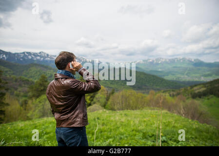 Man calling phone on the mountain Stock Photo