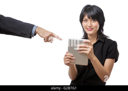 Studio shot of a young beautiful happy business woman using tablet computer with a male colleague arm in a suit coming into the  Stock Photo