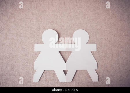 paper dolls holding hands, teamwork partnership, friendship concept Stock Photo