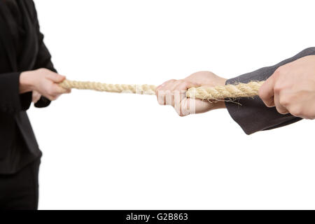 Close up studio shot of two office business workers, pulling on a large rope in a tug of war.  Isolated on white Stock Photo