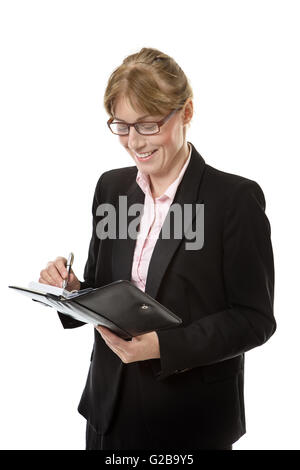 business woman wearing glasses is writing in her personal organiser isolated on white Stock Photo