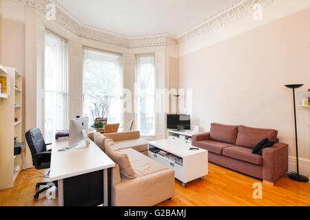 Pembridge Square, Notting Hill. View of a modern living with contemporary, neutral toned furniture. Large windows and high ceilings. Stock Photo