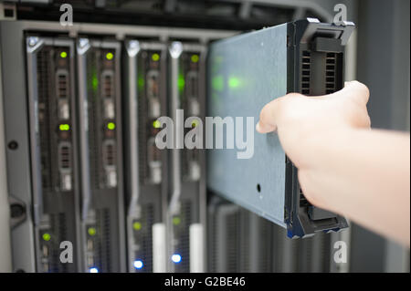 Man fix server network in data center room . Stock Photo
