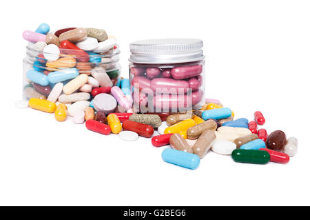 Jars or recipient with many colored pills isolated on white studio background as medical presentation concept Stock Photo