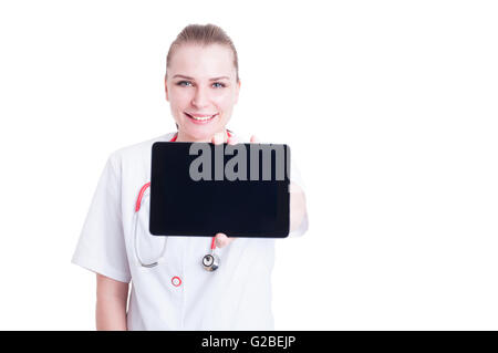 Smiling woman doctor or medic showing blank screen tablet with advertising copy space text area Stock Photo