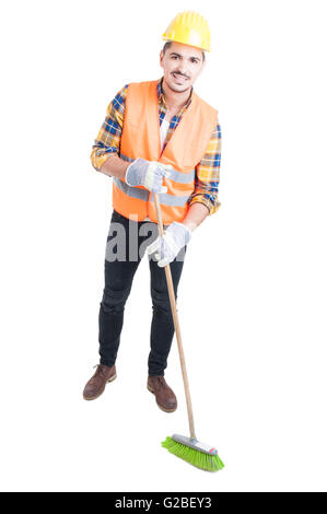 Cheerful engineer sweeping the floor with a broom as cleaning concept isolated on white Stock Photo