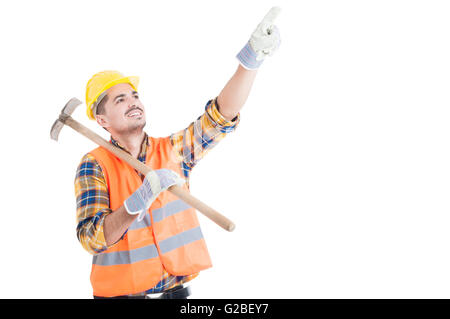 Portrait of happy engineer pointing up and holding shovel with copy space isolated on white background Stock Photo