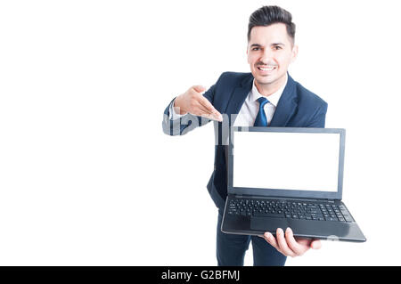 Portrait of cheerful male executive presenting a laptop with empty screen and copy space isolated on white Stock Photo