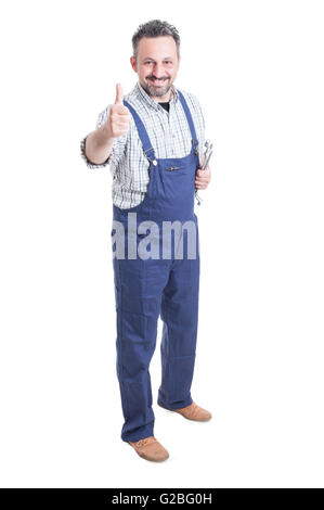 Full body of cheerful mechanic with spanner showing thumbup as professional services concept isolated on white Stock Photo