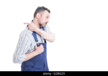 Young repairman putting overalls and getting ready for work as protection workwear with copy space isolated on white Stock Photo
