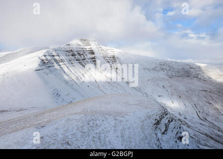 Morning light hits the north face of snow covered Pen Y Fan in the ...