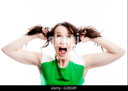 Screaming woman tearing at her own hair Stock Photo