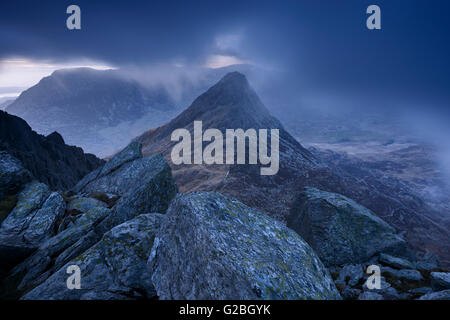 Tryfan surrounded by low cloud at dusk in the Glyder Mountains, Snowdonia. Stock Photo