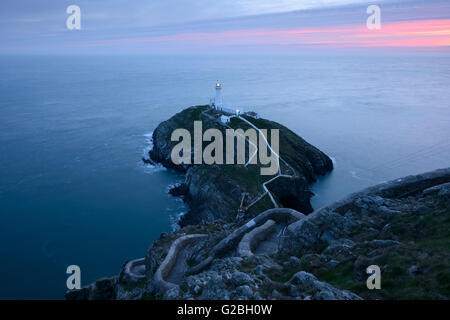 South Stack Lighthouse, Anglesey, during a colourful sunset. Stock Photo