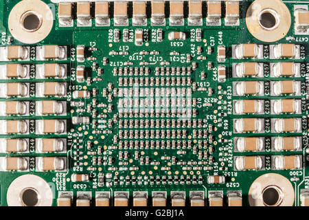 Small electronic components on green circuit board macro closeup Stock Photo