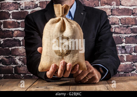 Man holding a big sack of money Stock Photo