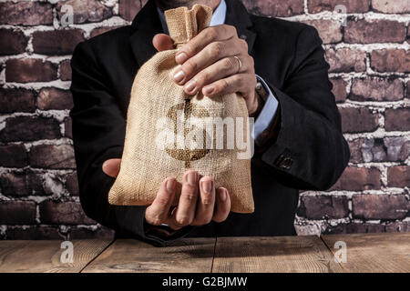 Man holding a big sack of money Stock Photo