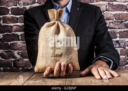 Man holding a big sack of money Stock Photo