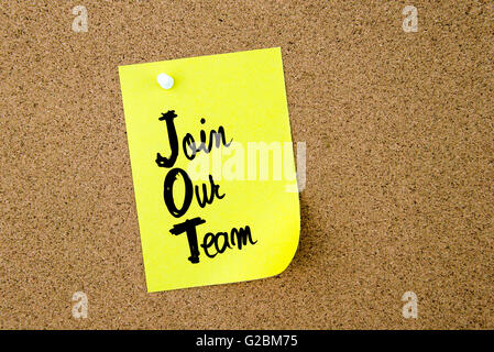 Business Acronym JOT Join Our Team written on yellow paper note pinned on cork board with white thumbtack, copy space available Stock Photo
