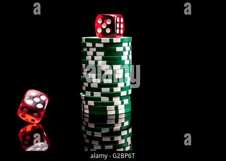 Dices and chips isolated on black background with reflexion Stock Photo