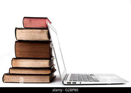 Old Books Pile With Silver Laptop and Stethoscope Isolated on White Background Stock Photo
