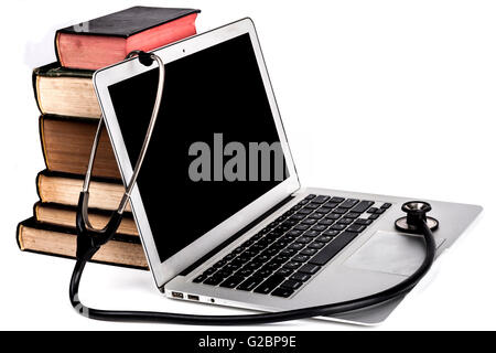 Old Books Pile With Silver Laptop and Stethoscope Isolated on White Background Stock Photo