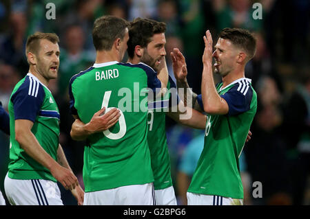 Northern Ireland's Will Grigg (centre right) celebrates scoring his side's third goal during the International Friendly at Windsor Park, Belfast. Stock Photo